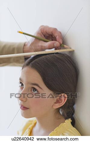 Stock Image - Girl (8-9) being measured. Fotosearch