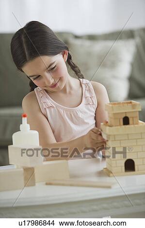 Girl (8-9) building toy castle View Large Photo Image Picture - Girl (8-9) building toy castle. Fotosearch