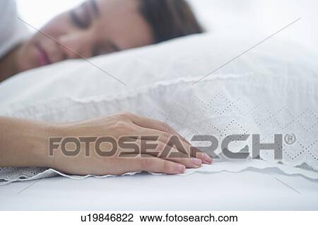 Happy young woman sleeping in bed View Large Photo Image Stock Image - Happy young woman sleeping in bed. Fotosearch