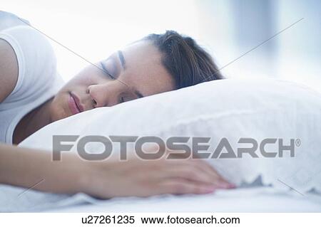 Happy young woman sleeping in bed View Large Photo Image Stock Photography - Happy young woman sleeping in bed. Fotosearch