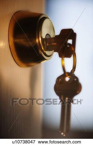 Keys hanging from front door View Large Photo Image Stock Photo - Keys hanging from front door. Fotosearch