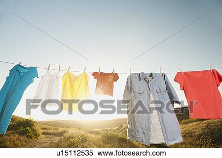 Laundry hanging on clothesline against blue sky View Large Photo Image Stock Photography - Laundry hanging on clothesline against blue sky. Fotosearch