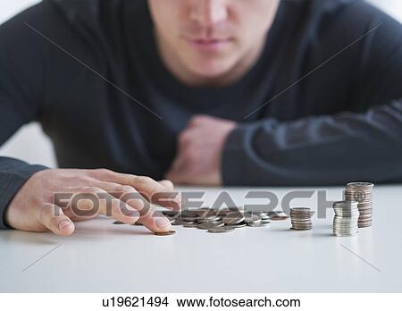 Picture - Man counting coins. Fotosearch