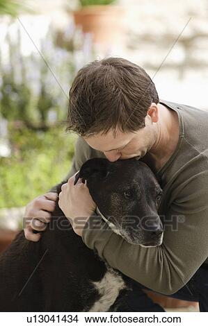 Man hugging dog View Large Photo Image Picture - Man hugging dog. Fotosearch