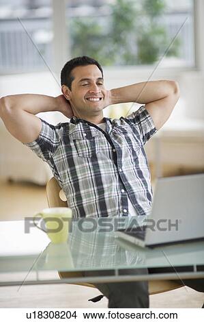 Picture - Man looking at laptop. Fotosearch