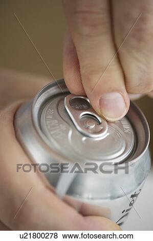 Stock Photo - Man opening drink can. Fotosearch