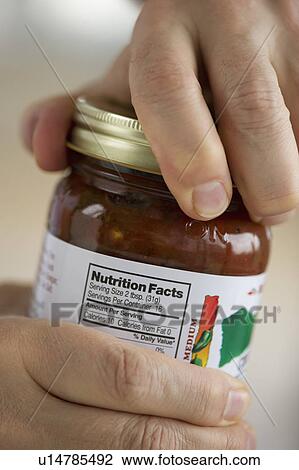 Stock Image - Man opening jar. Fotosearch