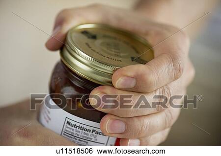 Stock Photograph - Man opening jar. Fotosearch