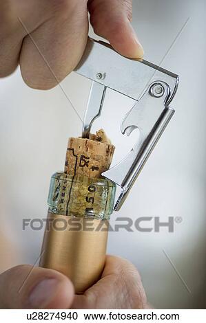 Man opening wine bottle View Large Photo Image Stock Image - Man opening wine bottle. Fotosearch