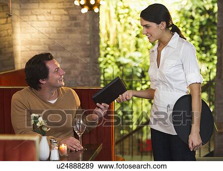 Stock Photo - Man ordering food in restaurant. Fotosearch