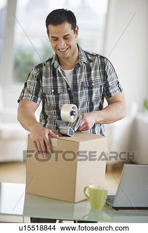 Picture - Man packing box. Fotosearch