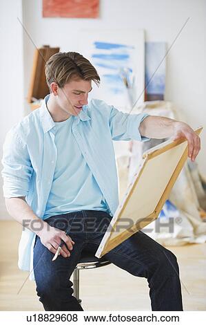 Man painting picture in studio View Large Photo Image Stock Photo - Man painting picture in studio. Fotosearch