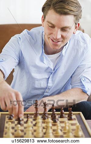 Stock Image - Man playing chess. Fotosearch