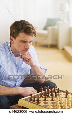 Stock Photograph - Man playing chess. Fotosearch