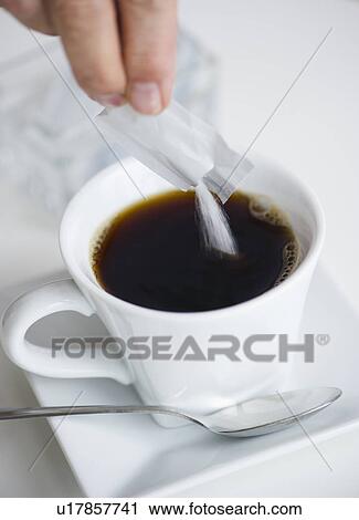 Man pouring sweetener into coffee View Large Photo Image Stock Image - Man pouring sweetener into coffee. Fotosearch