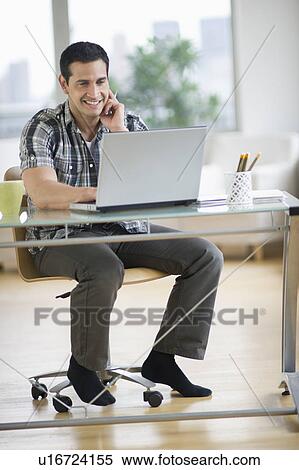 Man using laptop in office View Large Photo Image Stock Photography - Man using laptop in office. Fotosearch