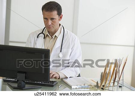Stock Image - mature doctor working in office. Fotosearch
