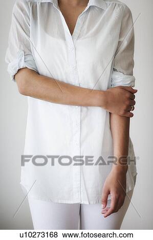 Mid section of woman dressed in white View Large Photo Image Stock Photo - Mid section of woman dressed in white. Fotosearch