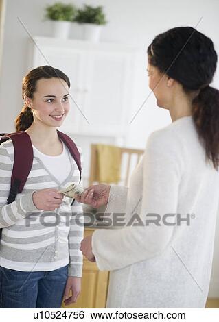 Mother giving money to teenage daughter (14-15) View Large Photo Image Stock Photograph - Mother giving money to teenage daughter (14-15). Fotosearch