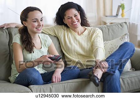 Stock Image - Mother talking to teenage daughter (14-15). Fotosearch