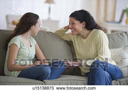 Stock Image - Mother talking to teenage daughter (14-15). Fotosearch