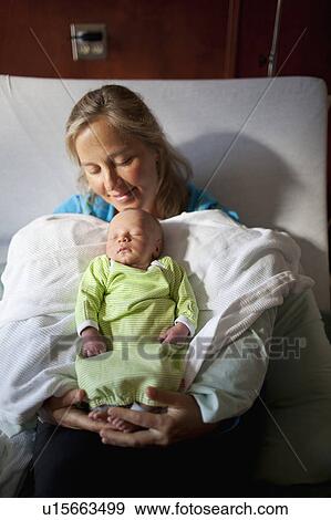Mother with baby boy (0-1 months) on hospital bed View Large Photo Image Stock Photo - Mother with baby boy (0-1 months) on hospital bed. Fotosearch