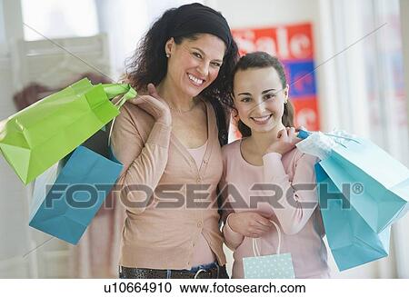 Stock Image - Mother with teenage girl (14-15) shopping. Fotosearch