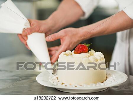Pastry chef decorating cake View Large Photo Image Stock Image - Pastry chef decorating cake. Fotosearch