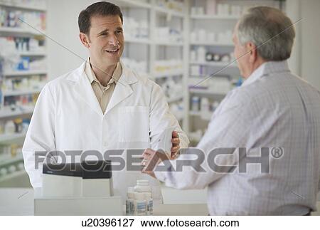 Pharmacist explaining use of medicine to patient View Large Photo Image Stock Photo - Pharmacist explaining use of medicine to patient. Fotosearch