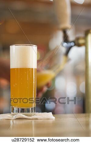 Pint of beer on bar counter View Large Photo Image Stock Image - Pint of beer on bar counter. Fotosearch