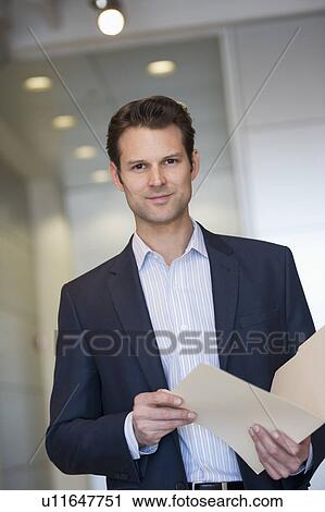 Portrait of businessman holding documents View Large Photo Image Stock Image - Portrait of businessman holding documents. Fotosearch