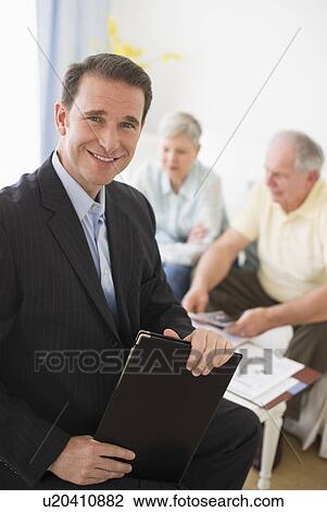 Portrait of businessman, senior couple in the background View Large Photo Image Stock Image - Portrait of businessman, senior couple in the background. Fotosearch