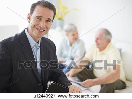 Stock Photo - Portrait of businessman, senior couple in the background. Fotosearch