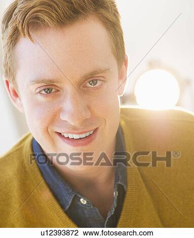 Stock Image - Portrait of cheerful young man. Fotosearch