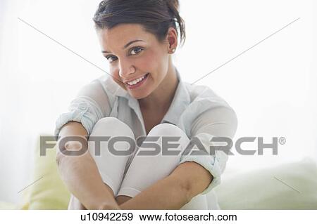 Stock Photo - Portrait of cheerful young woman. Fotosearch