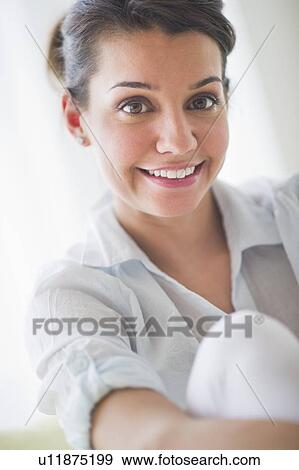 Stock Photo - Portrait of cheerful young woman. Fotosearch