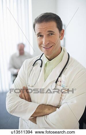 Picture - Portrait of doctor, senior couple in the background. Fotosearch