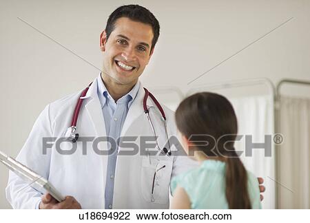 Stock Image - Portrait of doctor talking to girl (8-9). Fotosearch