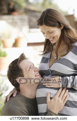 Stock Photo - Portrait of expecting couple. Fotosearch
