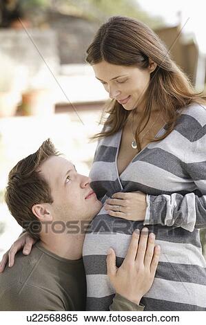 Stock Photography - Portrait of expecting couple. Fotosearch