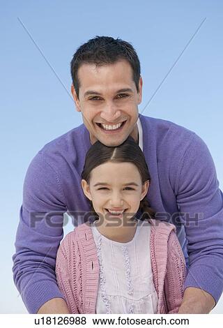 Portrait of father embracing daughter (8-9) View Large Photo Image Stock Photo - Portrait of father embracing daughter (8-9). Fotosearch