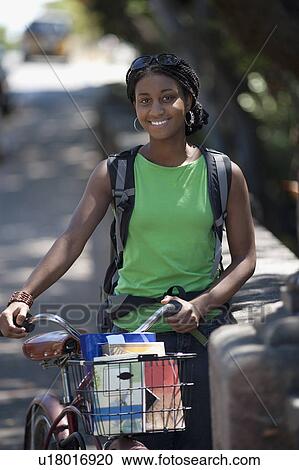 Portrait of female student with bicycle View Large Photo Image Stock Image - Portrait of female student with bicycle. Fotosearch
