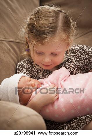 Portrait of girl (2-3) holding newborn girl (0-1months) View Large Photo Image Stock Image - Portrait of girl (2-3) holding newborn girl (0-1months) . Fotosearch