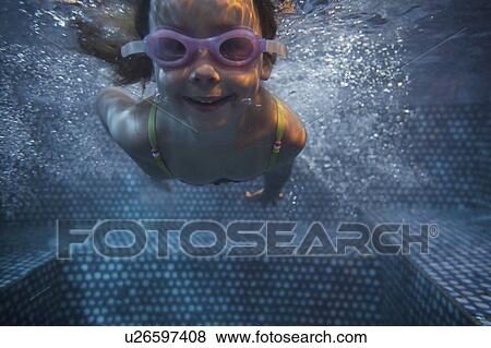 Portrait of girl (4-5) swimming underwater View Large Photo Image Stock Photo - Portrait of girl (4-5) swimming underwater. Fotosearch