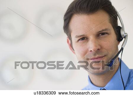 Stock Photo - Portrait of male customer service representative. Fotosearch