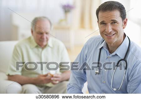Stock Photograph - Portrait of male doctor with senior patient in background. Fotosearch