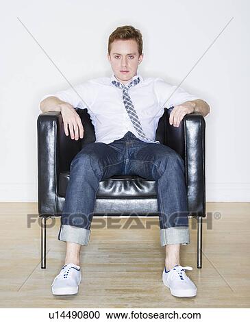 Stock Image - Portrait of man sitting in armchair. Fotosearch