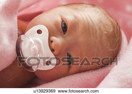 Stock Photo - Portrait of newborn girl (0-1months) . Fotosearch