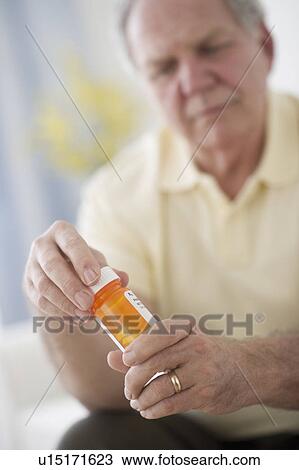 Portrait of senior man taking pills View Large Photo Image Stock Image - Portrait of senior man taking pills. Fotosearch