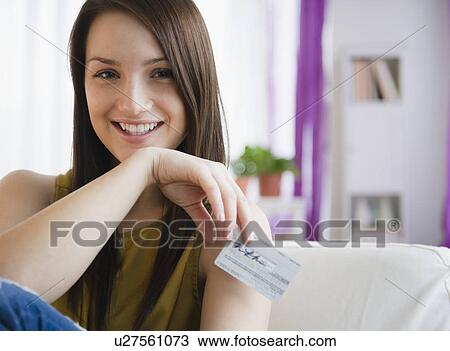 Portrait of smiling young woman holding credit card View Large Photo Image Stock Image - Portrait of smiling young woman holding credit card. Fotosearch